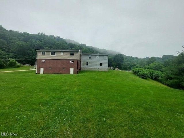 4985 State Route 213, Toronto, OH 43964 - rear view of property featuring a lawn and a forest view