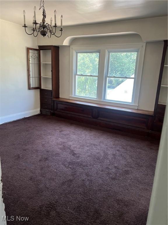 20520 Ball Ave, Euclid, OH 44123 - empty room featuring dark colored carpet and a chandelier