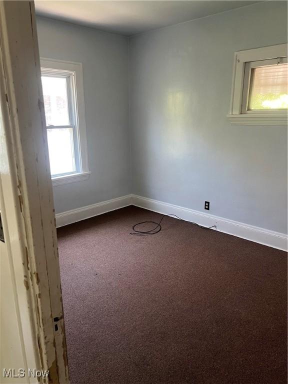20520 Ball Ave, Euclid, OH 44123 - empty room featuring dark colored carpet and baseboards