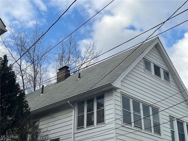 20520 Ball Ave, Euclid, OH 44123 - view of home's exterior featuring a chimney and roof with shingles