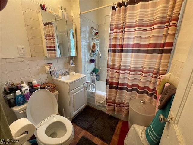 20520 Ball Ave, Euclid, OH 44123 - bathroom featuring tile walls, shower / bath combination with curtain, vanity, and wood finished floors