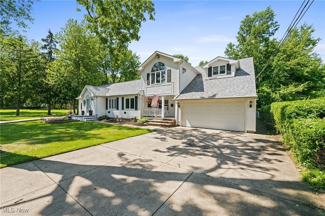 34765 Roberts Rd, Eastlake, OH 44095 - traditional home with roof with shingles, driveway, a front lawn, and a garage