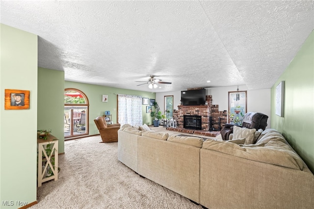 34765 Roberts Rd, Eastlake, OH 44095 - living area with a brick fireplace, a textured ceiling, ceiling fan, carpet floors, and plenty of natural light