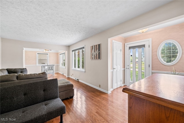 34765 Roberts Rd, Eastlake, OH 44095 - living room with healthy amount of natural light, wood finished floors, and a textured ceiling