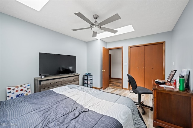 34765 Roberts Rd, Eastlake, OH 44095 - bedroom featuring a skylight, light wood-type flooring, a closet, and ceiling fan