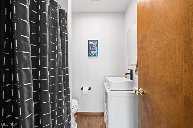 34765 Roberts Rd, Eastlake, OH 44095 - bathroom with vanity, wood finished floors, and a shower with curtain
