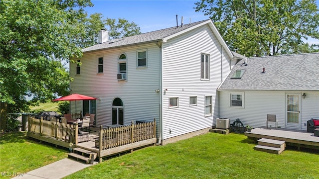 34765 Roberts Rd, Eastlake, OH 44095 - back of house featuring a chimney, a yard, a wooden deck, and an outdoor hangout area
