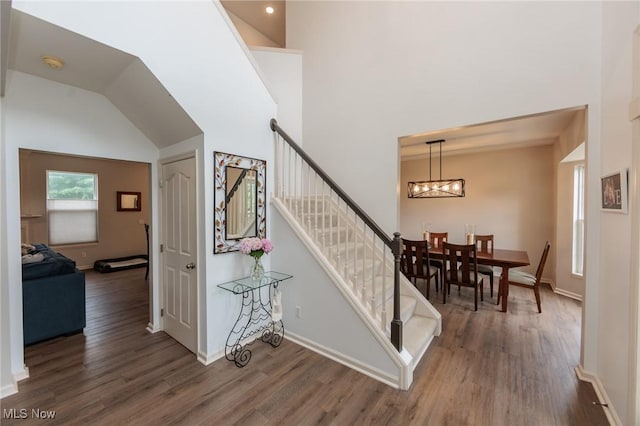 100 Hartford Ct, Broadview Heights, OH 44147 - staircase featuring wood finished floors, a chandelier, and high vaulted ceiling