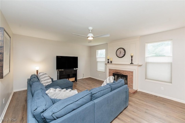 100 Hartford Ct, Broadview Heights, OH 44147 - living room featuring light wood-style flooring, a ceiling fan, and a brick fireplace