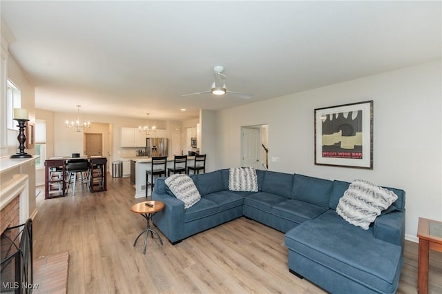 100 Hartford Ct, Broadview Heights, OH 44147 - living area with a chandelier, light wood-style floors, ceiling fan, and a brick fireplace