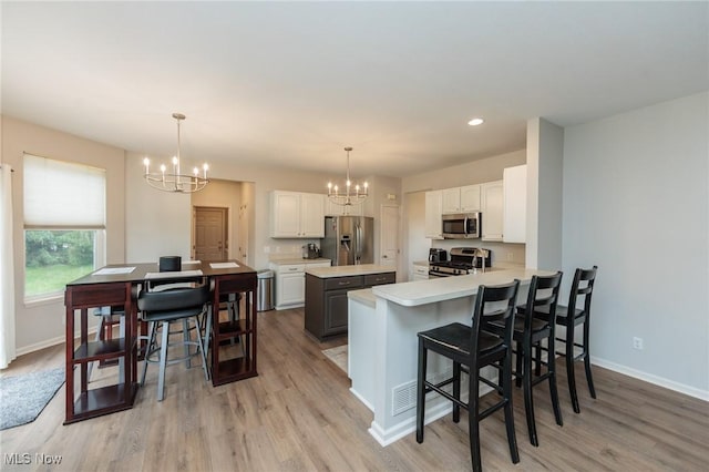 100 Hartford Ct, Broadview Heights, OH 44147 - kitchen with stainless steel appliances, a chandelier, light wood-style flooring, light countertops, and recessed lighting