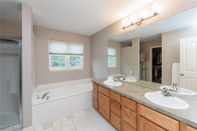 100 Hartford Ct, Broadview Heights, OH 44147 - full bathroom featuring a bath, a stall shower, double vanity, and a walk in closet