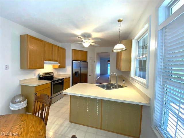 10517 W Ravine View Ct, North Royalton, OH 44133 - kitchen with appliances with stainless steel finishes, under cabinet range hood, a peninsula, light countertops, and pendant lighting