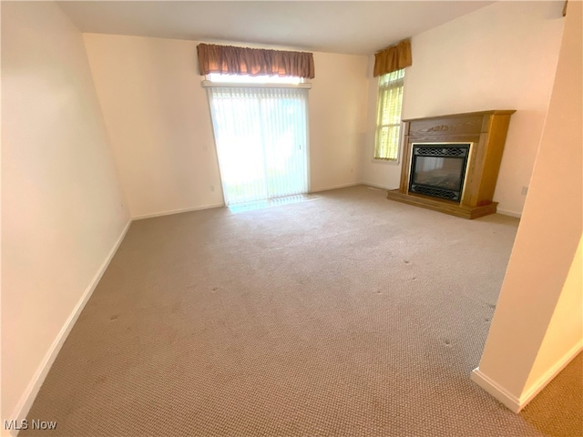 10517 W Ravine View Ct, North Royalton, OH 44133 - unfurnished living room with light colored carpet and a glass covered fireplace