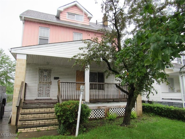 3298 E 143rd St, Cleveland, OH 44120 - view of front of house featuring a porch and a chimney