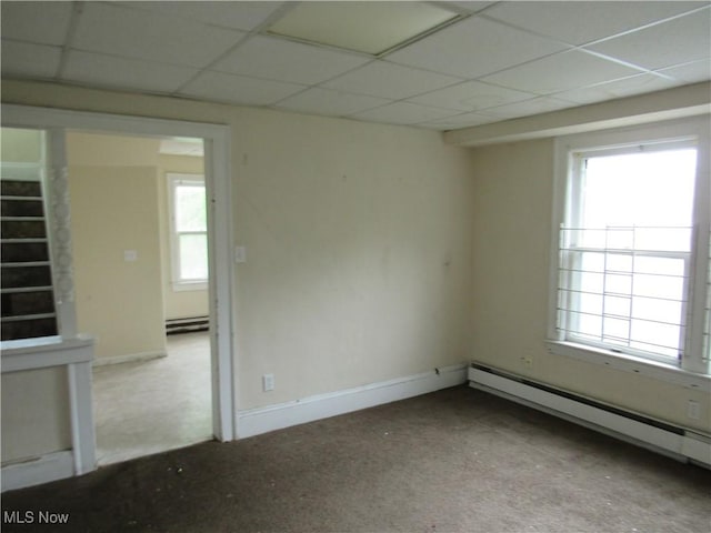 3298 E 143rd St, Cleveland, OH 44120 - carpeted empty room featuring a baseboard radiator and a drop ceiling