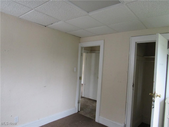 3298 E 143rd St, Cleveland, OH 44120 - unfurnished bedroom featuring a drop ceiling, a closet, and concrete floors