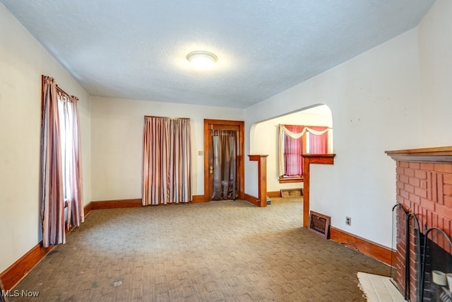516 Floyd St, Akron, OH 44310 - carpeted living room with a fireplace and a textured ceiling