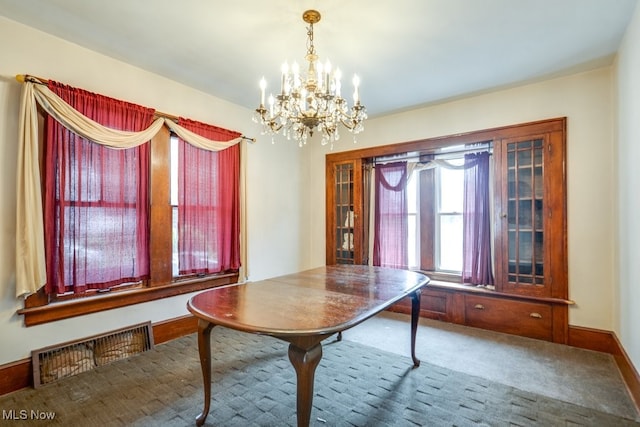 516 Floyd St, Akron, OH 44310 - dining room featuring a chandelier and carpet flooring