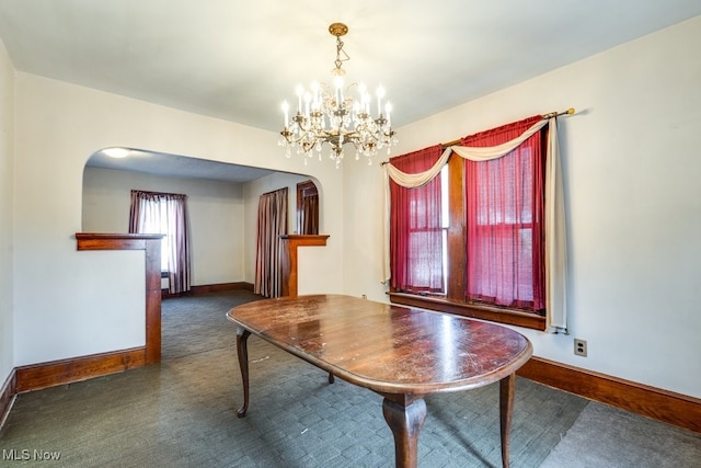 516 Floyd St, Akron, OH 44310 - carpeted dining area featuring arched walkways and a chandelier
