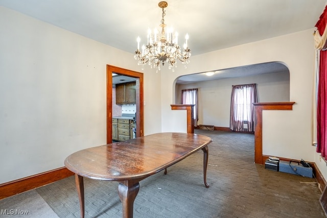516 Floyd St, Akron, OH 44310 - carpeted dining room featuring arched walkways and a chandelier