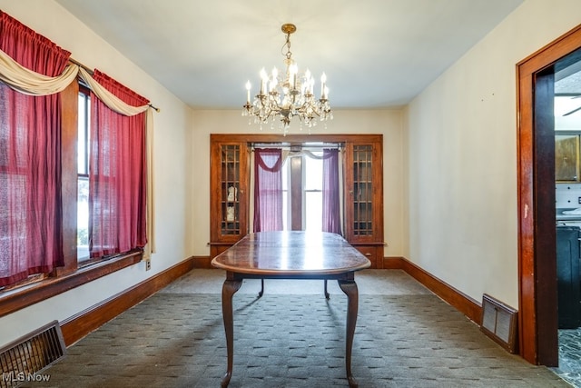 516 Floyd St, Akron, OH 44310 - carpeted dining room featuring healthy amount of natural light and a chandelier