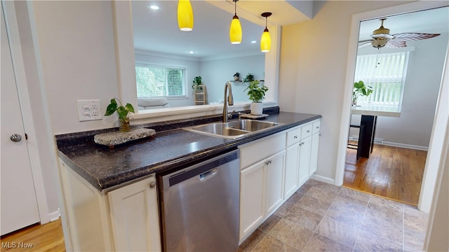 3162 W 231st St, North Olmsted, OH 44070 - kitchen featuring stainless steel dishwasher, dark countertops, white cabinets, ceiling fan, and pendant lighting
