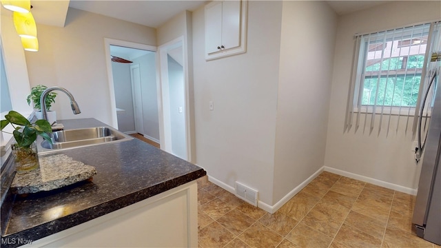 3162 W 231st St, North Olmsted, OH 44070 - kitchen featuring white cabinets and dark countertops