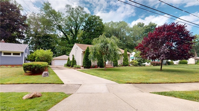 3162 W 231st St, North Olmsted, OH 44070 - view of front of house featuring an outbuilding, a front lawn, and a detached garage