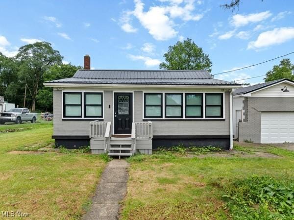 345 Ritchie Ave, Weirton, WV 26062 - view of front of home featuring a chimney, a front lawn, and a garage