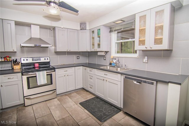 1333 Overlook Dr, Weirton, WV 26062 - kitchen featuring wall chimney range hood, appliances with stainless steel finishes, backsplash, and ceiling fan