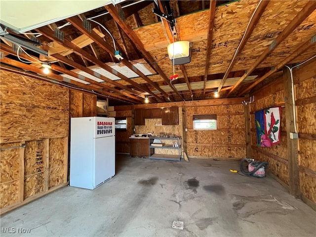 484 Louella Ave, Chester, WV 26034 - garage with freestanding refrigerator and a garage door opener