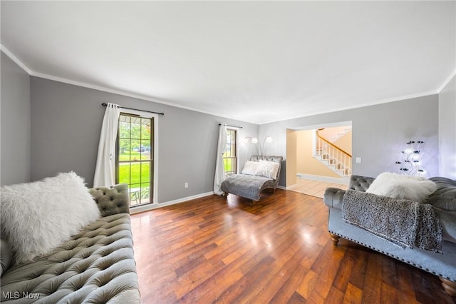 1141 Las Olas Blvd NW, North Canton, OH 44720 - living area with stairway, crown molding, and wood finished floors