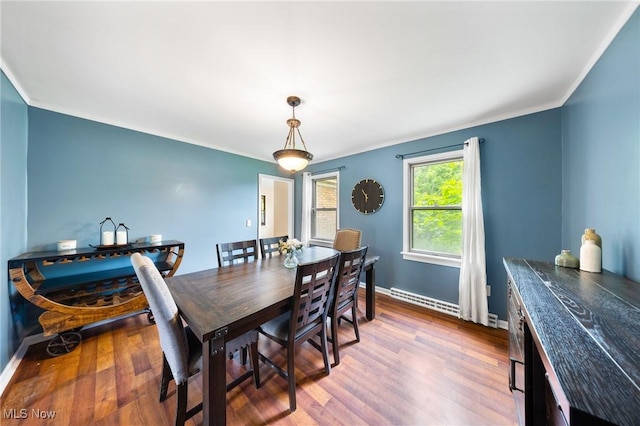 1141 Las Olas Blvd NW, North Canton, OH 44720 - dining room featuring baseboard heating, wood finished floors, and crown molding