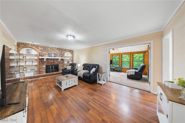 1141 Las Olas Blvd NW, North Canton, OH 44720 - living room with a fireplace, dark wood-style flooring, and crown molding