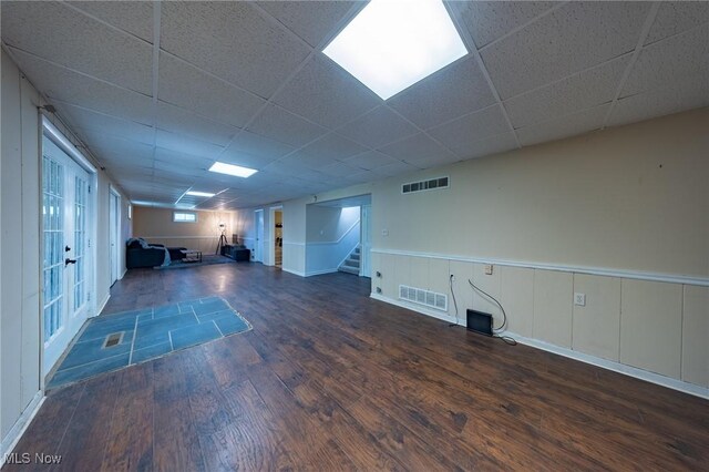 1141 Las Olas Blvd NW, North Canton, OH 44720 - unfurnished living room with wood finished floors, stairs, and a paneled ceiling