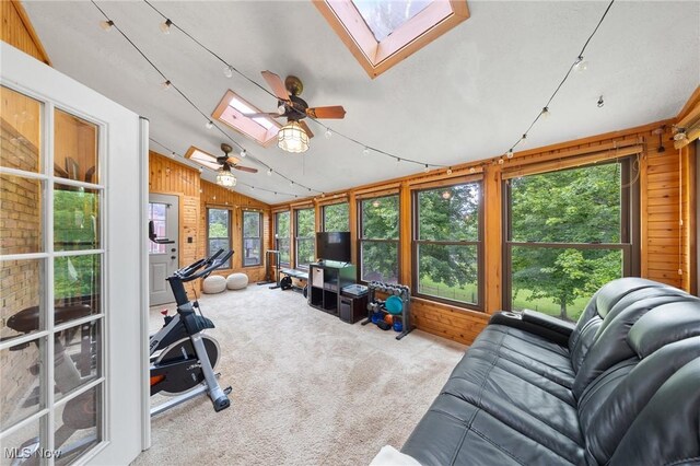 1141 Las Olas Blvd NW, North Canton, OH 44720 - sunroom featuring a skylight, wood walls, carpet, and lofted ceiling