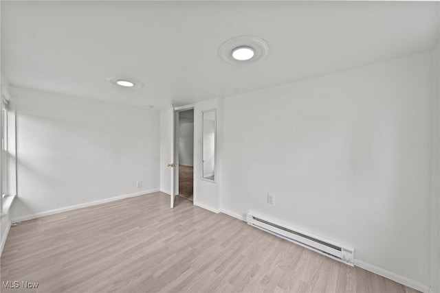 1170 Moneta Ave, Aurora, OH 44202 - unfurnished room featuring a baseboard heating unit and wood finished floors