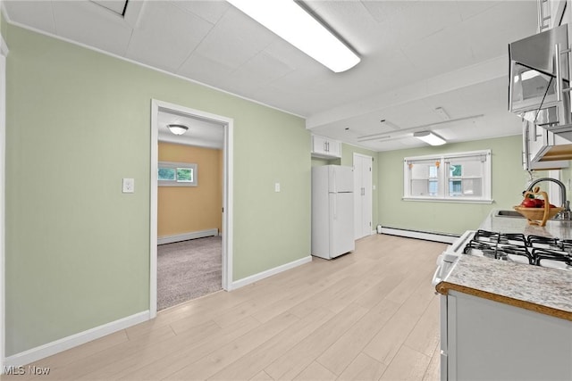 1170 Moneta Ave, Aurora, OH 44202 - kitchen with freestanding refrigerator, baseboard heating, white cabinets, light wood finished floors, and a baseboard heating unit