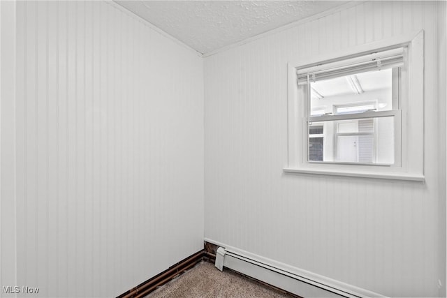 1170 Moneta Ave, Aurora, OH 44202 - spare room with a baseboard heating unit, a textured ceiling, and carpet floors