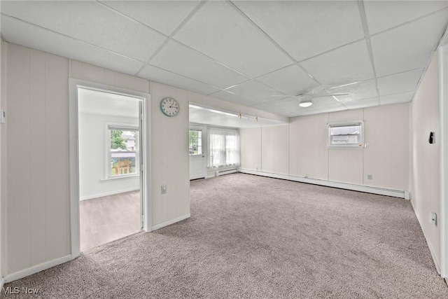 1170 Moneta Ave, Aurora, OH 44202 - carpeted spare room featuring a baseboard heating unit, a paneled ceiling, a wall unit AC, and healthy amount of natural light