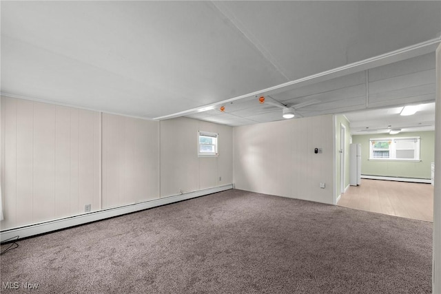 1170 Moneta Ave, Aurora, OH 44202 - carpeted empty room featuring healthy amount of natural light, a baseboard radiator, a baseboard heating unit, and a ceiling fan