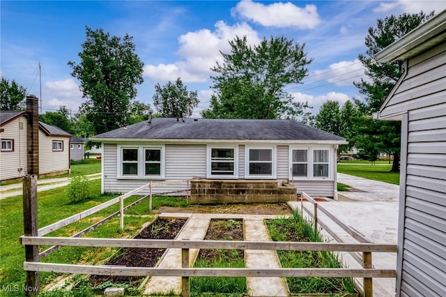 1170 Moneta Ave, Aurora, OH 44202 - rear view of property featuring a vegetable garden, a patio area, a yard, and a shingled roof