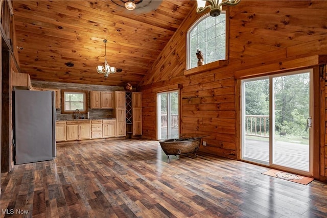 4278 Newbury Rd, Little Hocking, OH 45742 - kitchen featuring a chandelier, freestanding refrigerator, high vaulted ceiling, wooden walls, and dark wood finished floors