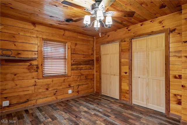 4278 Newbury Rd, Little Hocking, OH 45742 - unfurnished bedroom with multiple closets, wood walls, dark wood finished floors, and wood ceiling
