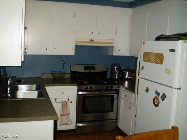 1222 N Carpenter Rd, Brunswick, OH 44212 - kitchen featuring freestanding refrigerator, stainless steel range with gas cooktop, under cabinet range hood, and white cabinets