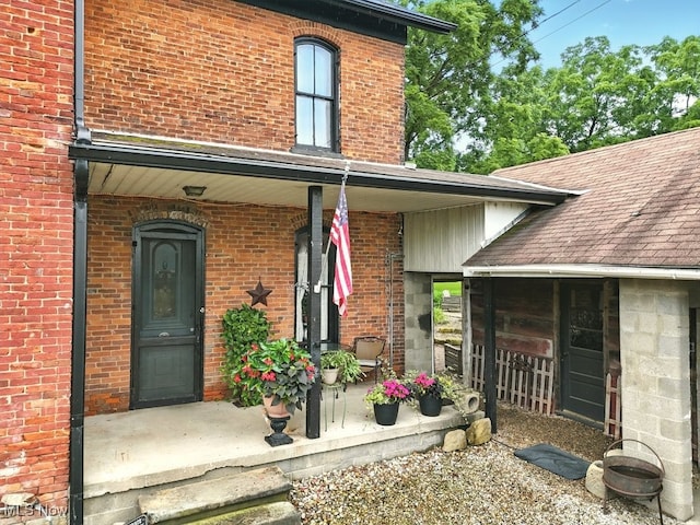7298 Akron Rd, Sterling, OH 44276 - doorway to property with covered porch and brick siding