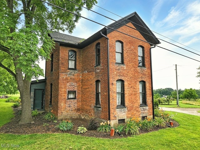 7298 Akron Rd, Sterling, OH 44276 - view of side of property with brick siding and a lawn