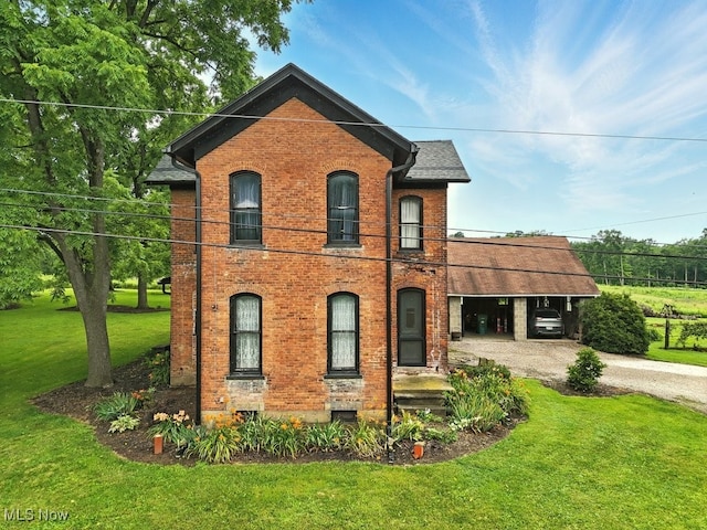 7298 Akron Rd, Sterling, OH 44276 - view of front of house with gravel driveway, a front lawn, and brick siding