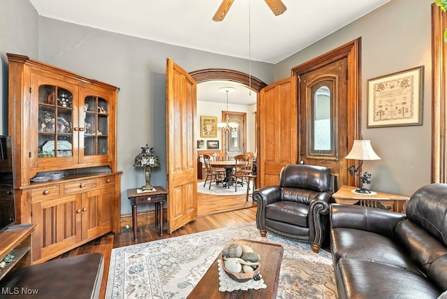 7298 Akron Rd, Sterling, OH 44276 - living room featuring dark wood-type flooring, ceiling fan, and a chandelier
